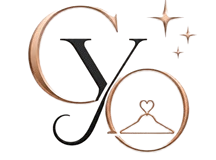 A luxury fashion logo on a solid blush-pink background featuring a central metallic rose-gold and black monogram. The letters C and O are rendered in a 3D metallic rose-gold finish, while a stylized black letter Y intertwines between them. Inside the ring of the letter O sits a thin rose-gold outline of a clothes hanger topped with a small heart hook. Three 3D rose-gold four-pointed stars sparkle above and to the right of the monogram. Directly beneath the graphic emblem, the brand name "CHECKYOUROYOTD" is spelled out in a dark serif typeface, with the letters "OUR" highlighted in metallic rose gold. A thin horizontal rose-gold line with a tiny outlined heart in the middle separates the brand name from the subtext below, which reads "YOUR OUTFIT. YOUR VOICE." in a clean, widely spaced uppercase font.